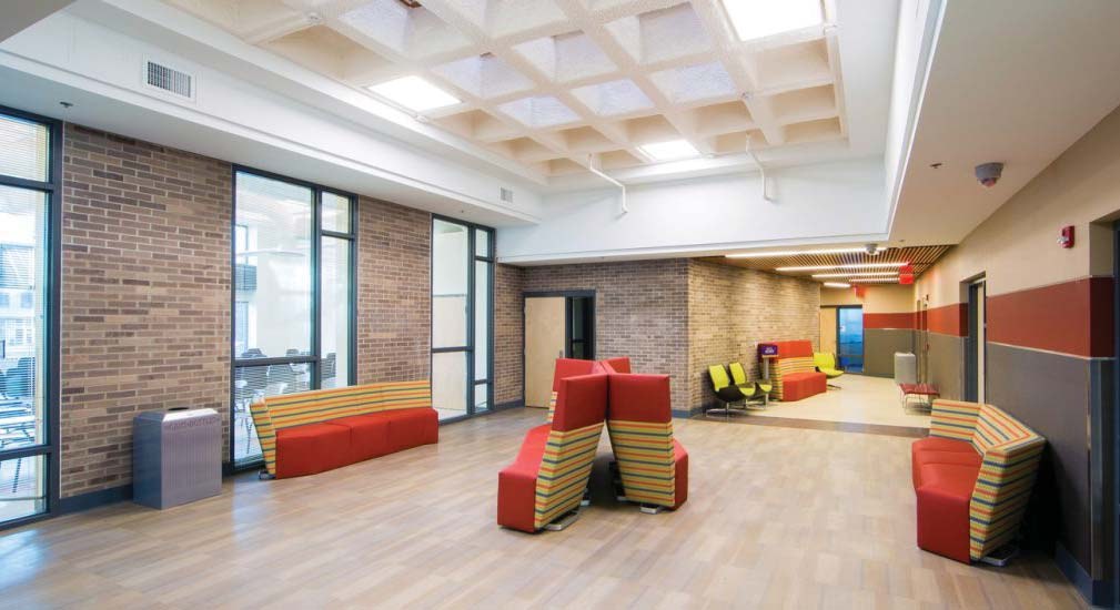 Renovated Mitchell Hall interior with skylit coffered ceiling and brick walls