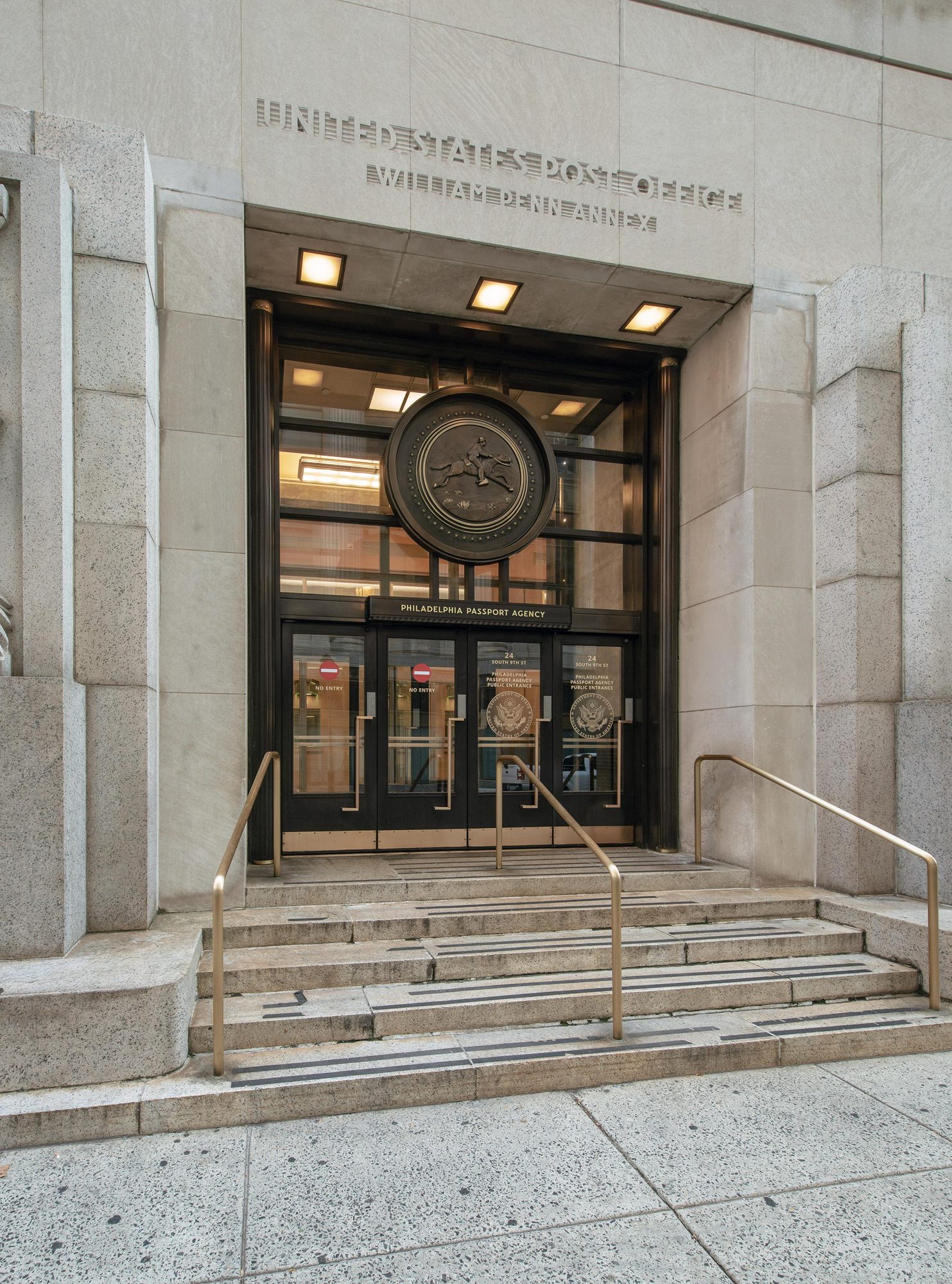 Bronze doors and seal at the passport agency entrance